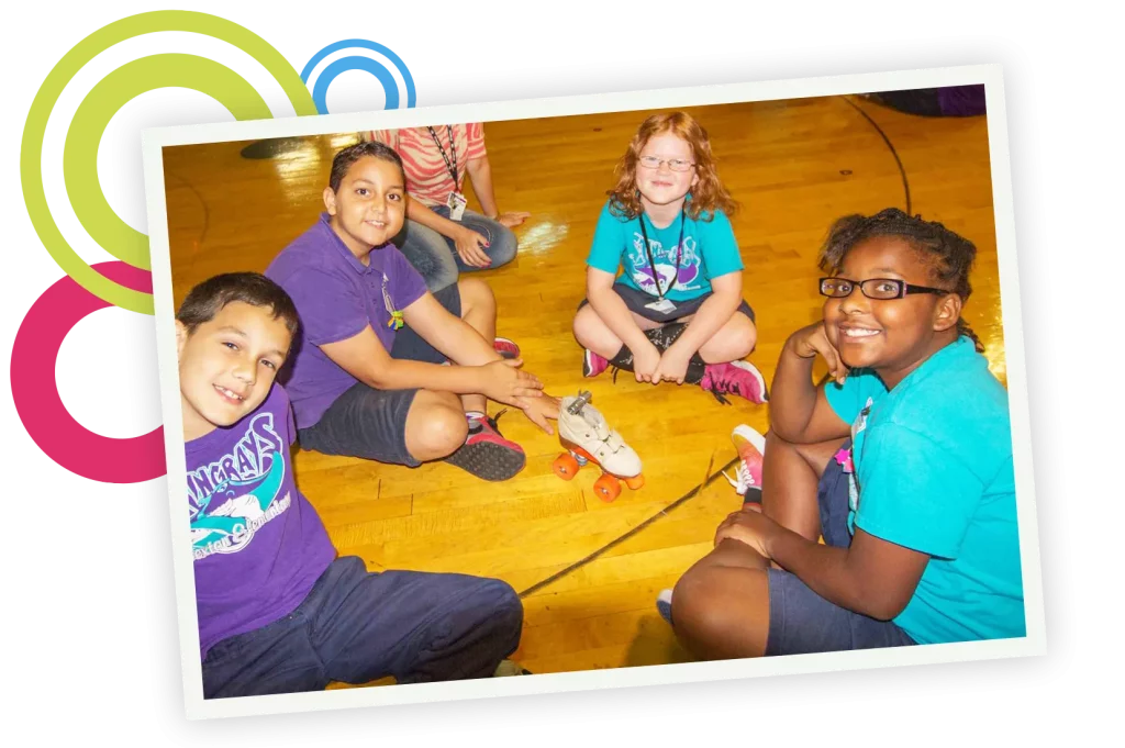 Four grade school students studying STEM using a roller skate